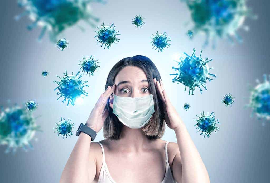 anxious woman is surrounded by germs. Get online anxiety treatment and online therapy with Synergy eTherapy