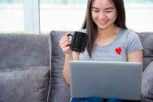teen holds a cup of hot cocoa during online therapy in Pennsylvania with Synergy eTherapy
