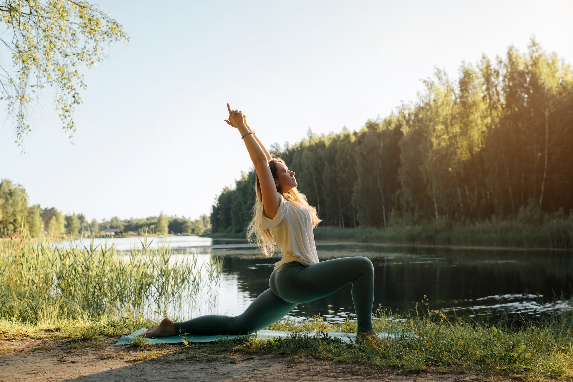 yoga in nature young woman practicing yoga on lake at sunset summer fitness model standing on